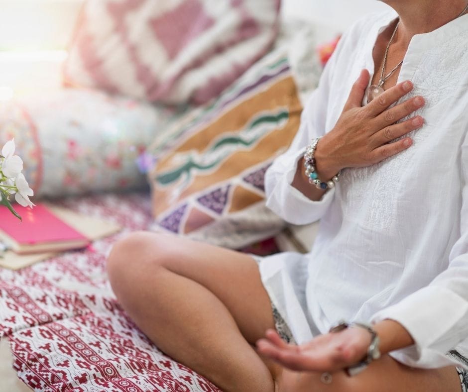 woman meditating with EQness
