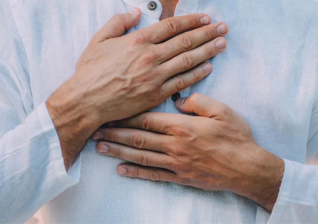 man with his hand over his heart. Practicing mindfulness and self-care with EQness Sydney