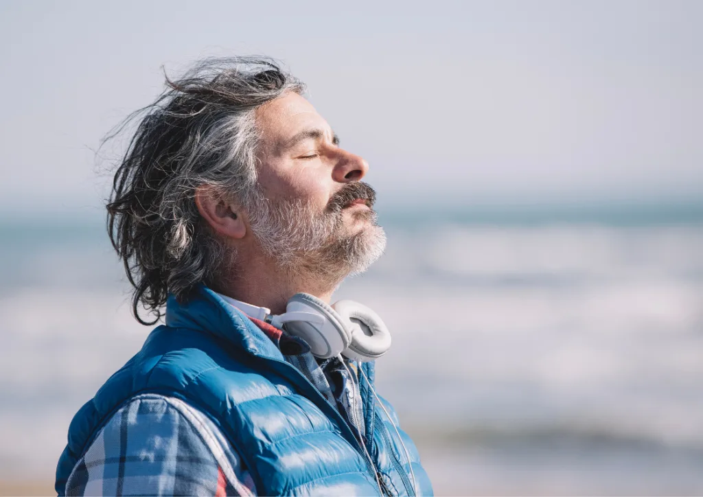 Man practicing mindfulness near the sea, reflecting inner calm and presence after EQness session in Sydney