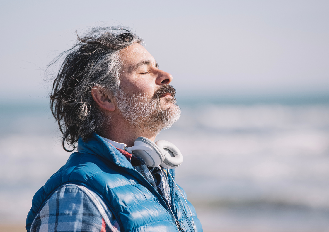 Man practicing mindfulness near the sea, reflecting inner calm and presence after EQness session in Sydney