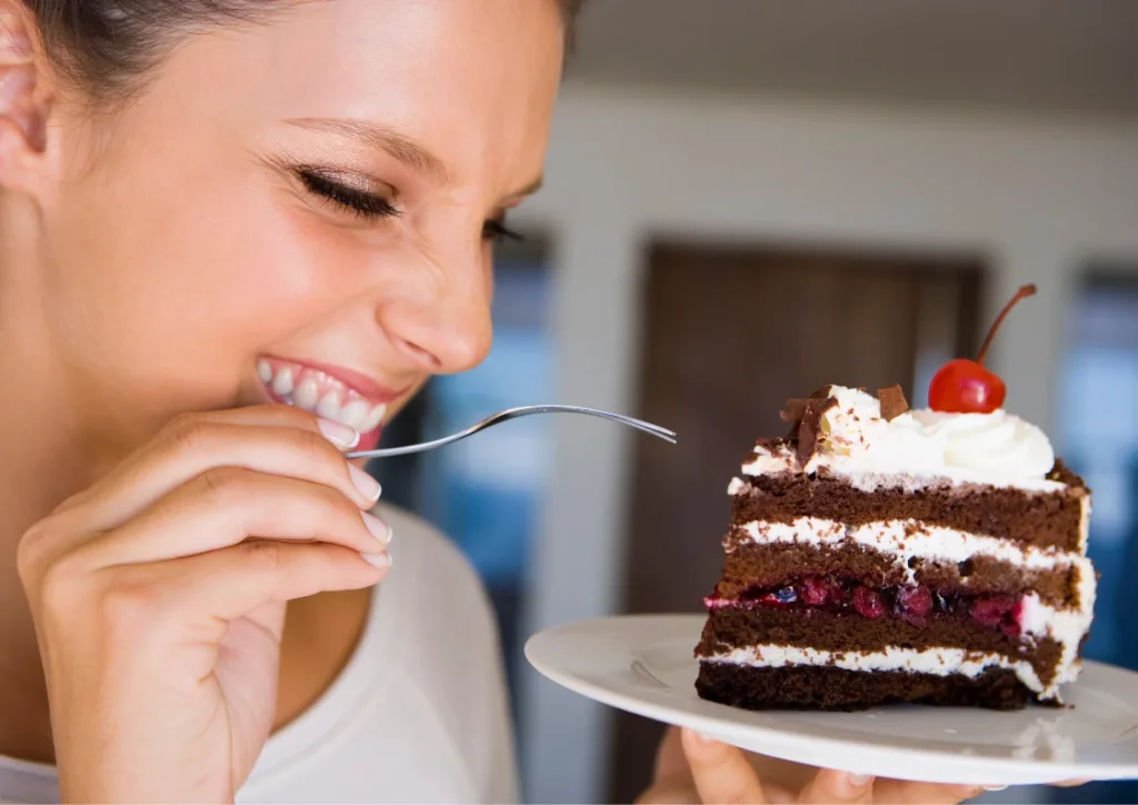 Girl happy eating a chocolate cake to promote mindfulness programs for healthy eating and wellbeing by EQness in Sydney and worldwide